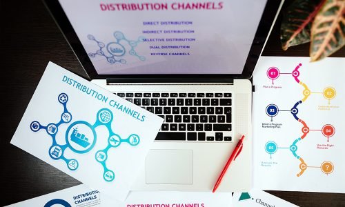 marketing distribution channels plan on office desk. Marketing manager desk with plans and strategy of distributive channels for new product.